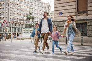 Happy young family on vacation. Parents and kids exploring European city.