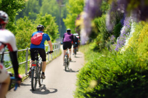 SWITZERLAND - MAY 11, 2018:Sportive middle age man cycling in sunny park in hot summer day. Nice sport for active people. Healthy lifestyle.